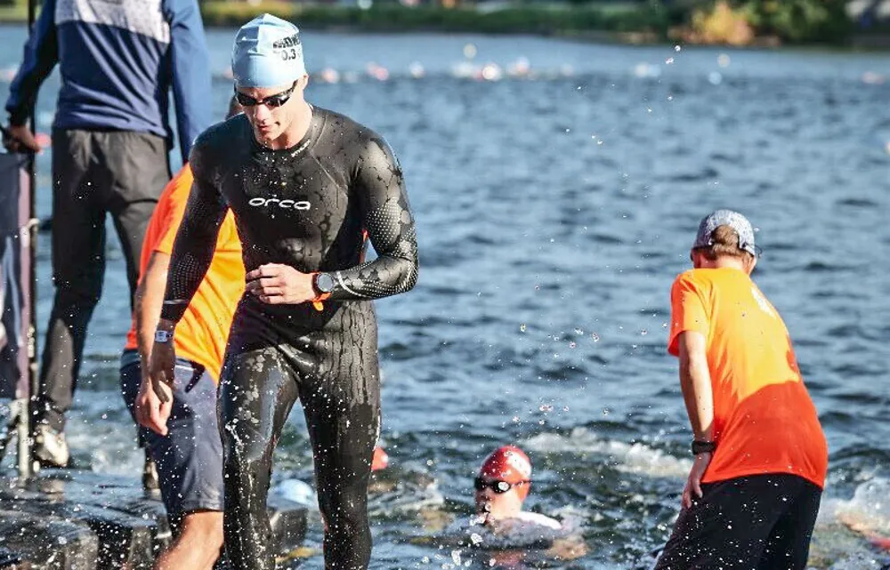 Danny Verdel walking out of the water after the swim at Ironman 70.3 Duisburg 2025