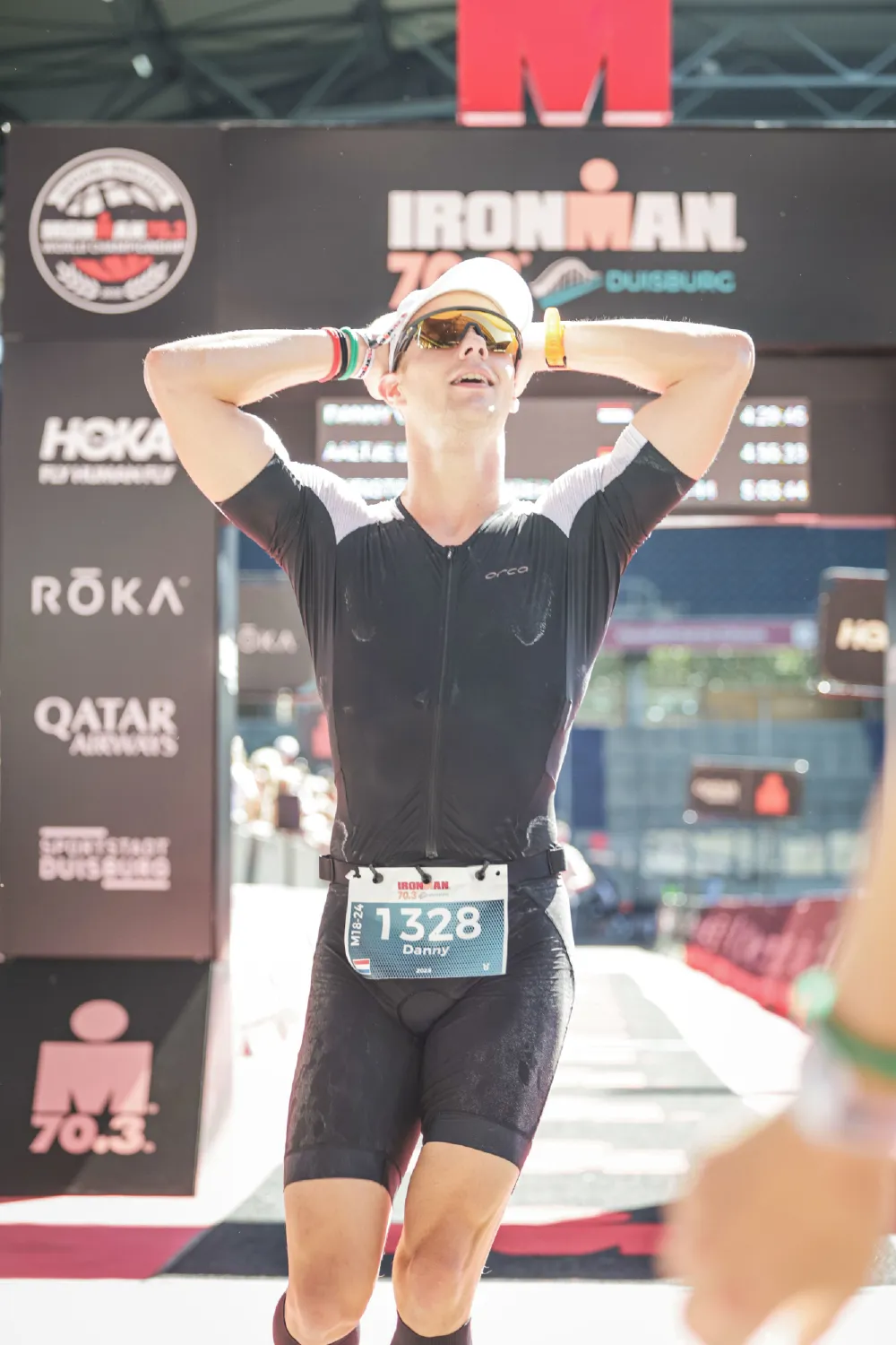 Danny Verdel with hands on head after crossing the finish line of Ironman 70.3 Duisburg 2025