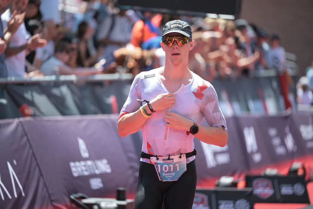 Danny Verdel zipping up the trisuit just before the finish of Ironman Frankfurt 2026