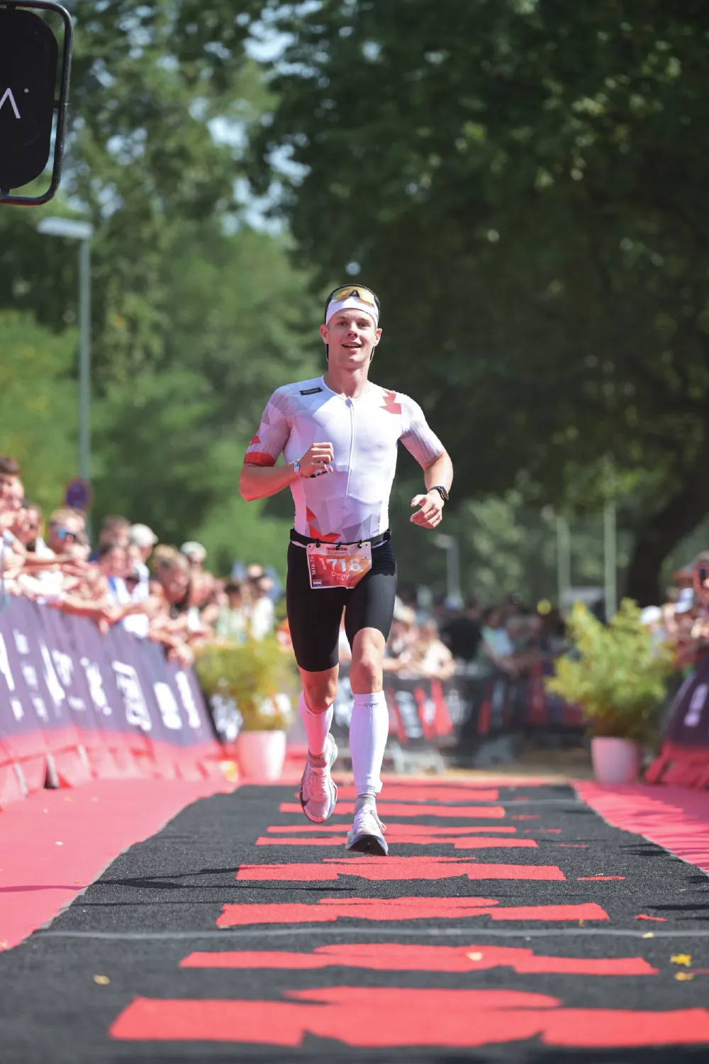 Danny Verdel smiling while running down the finish carpet at Ironman 70.3 Duisburg 2026